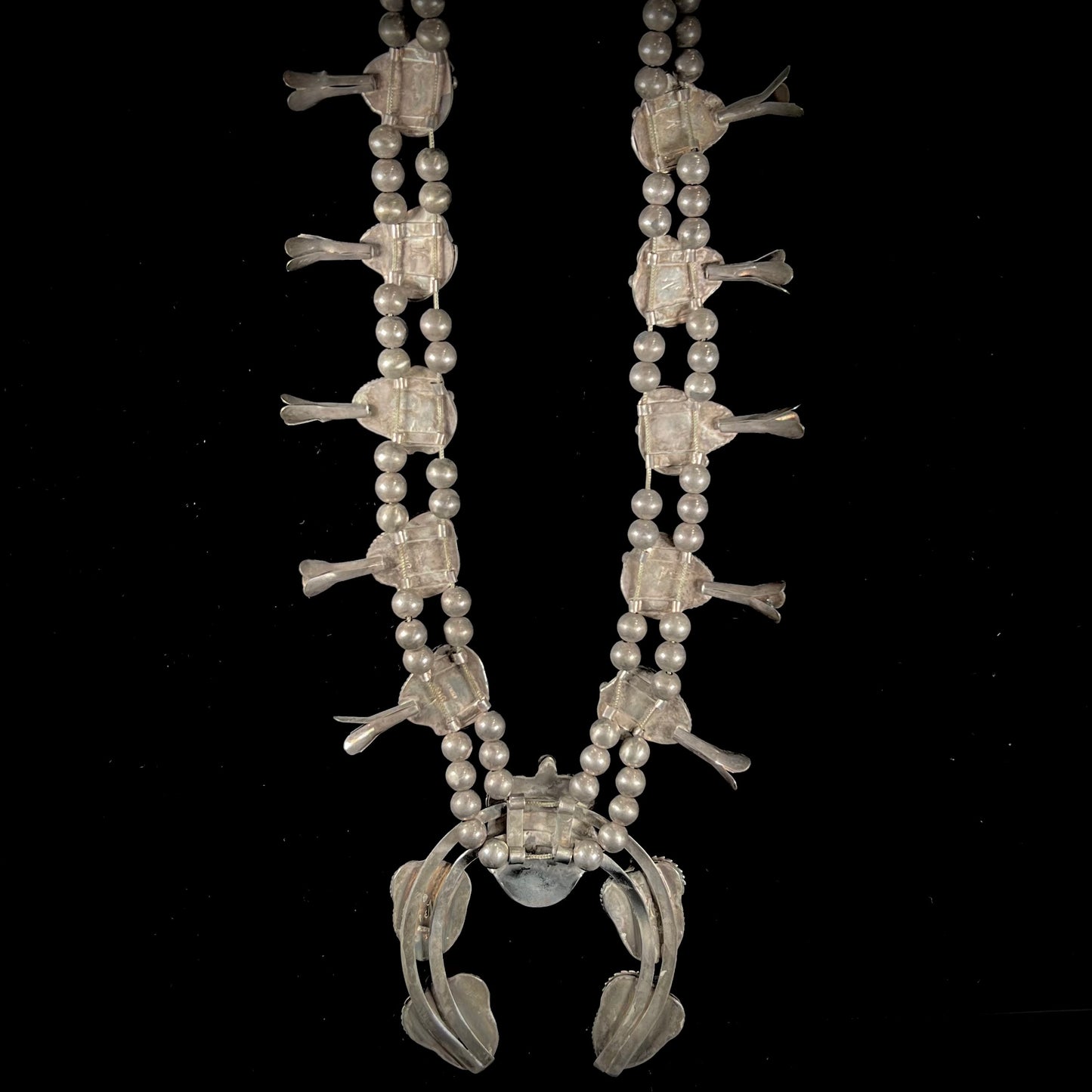 A silver Navajo men's squash blossom necklace set with Fox turquoise and Sonora turquoise.