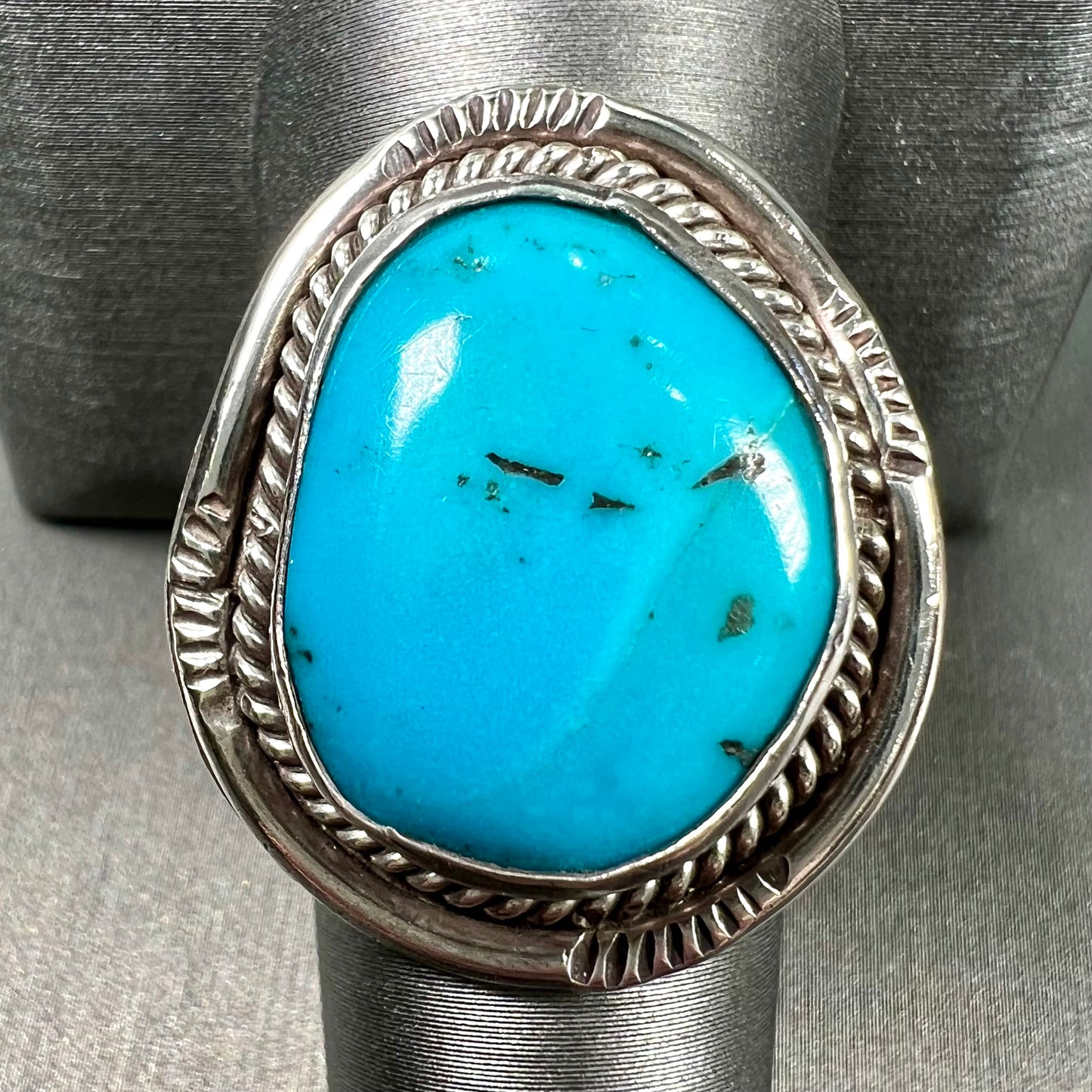 A men's silver, handmade, Navajo turquoise ring.