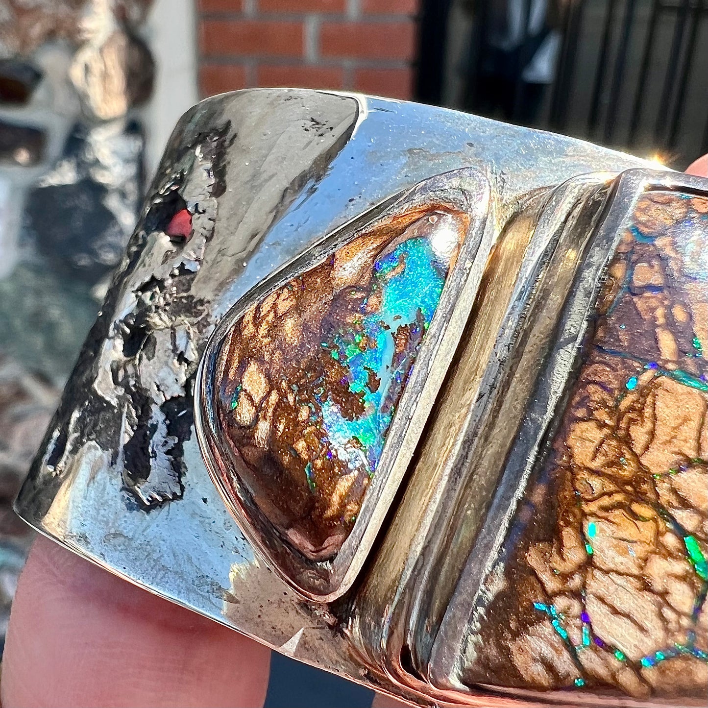 A men's sterling silver and copper infused cuff bracelet set with two boulder opal stones from Koroit, Australia.