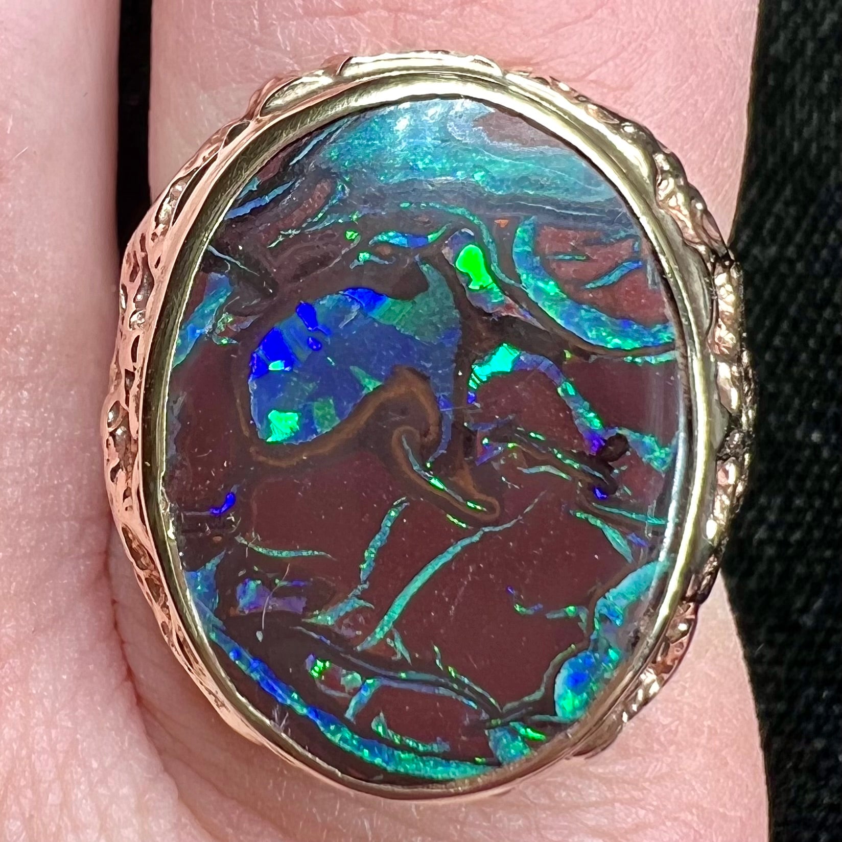 A men's yellow gold nugget style Koroit boulder opal solitaire ring.