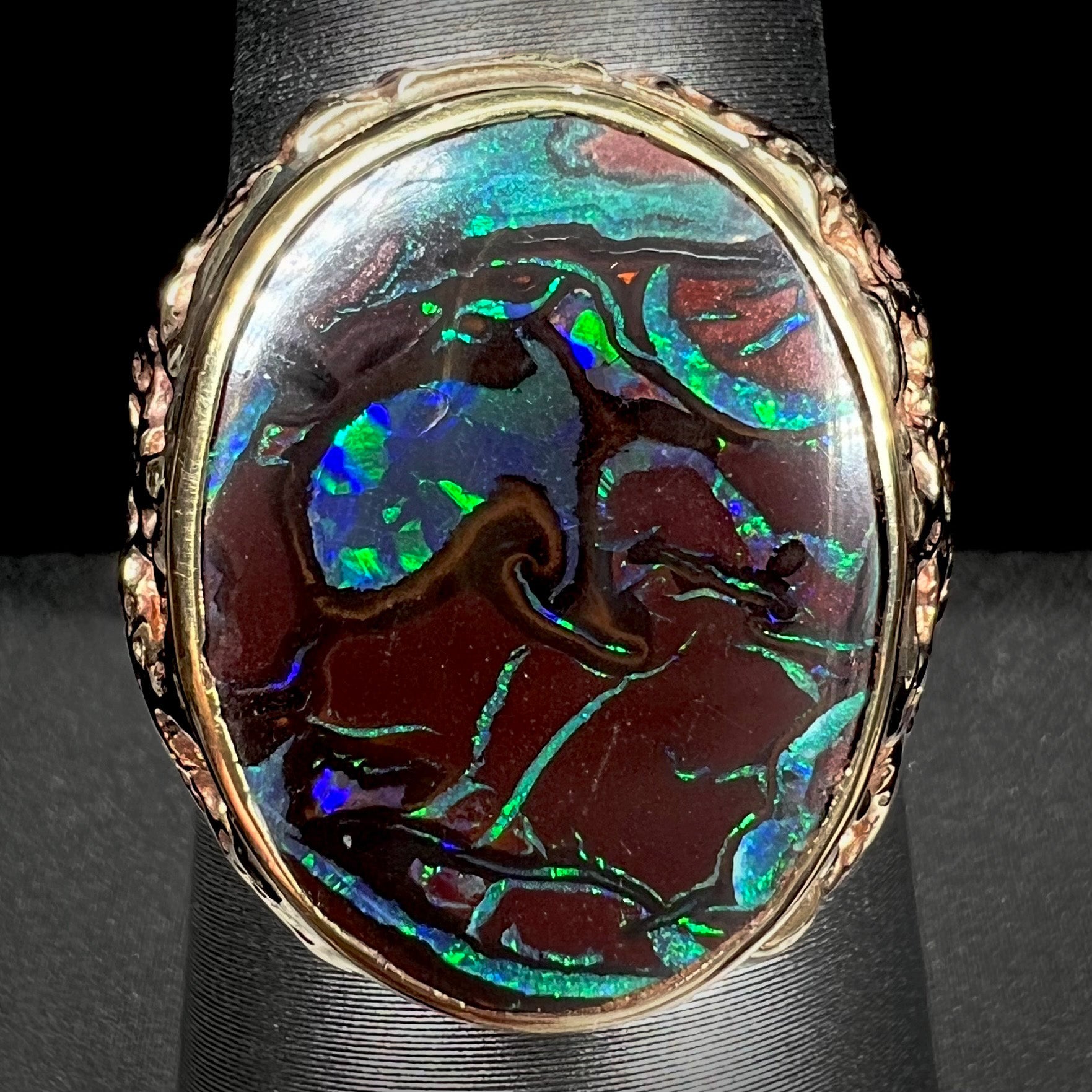 A men's yellow gold nugget style Koroit boulder opal solitaire ring.