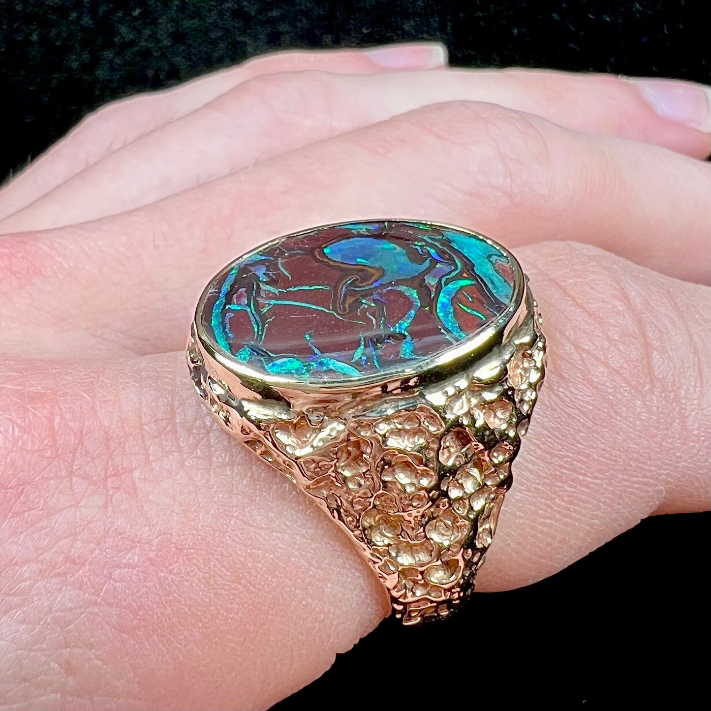 A men's yellow gold nugget style Koroit boulder opal solitaire ring.