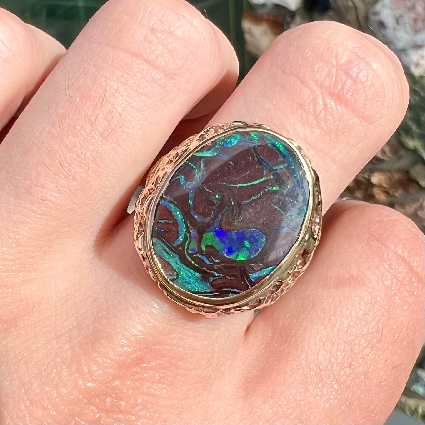 A men's yellow gold nugget style Koroit boulder opal solitaire ring.