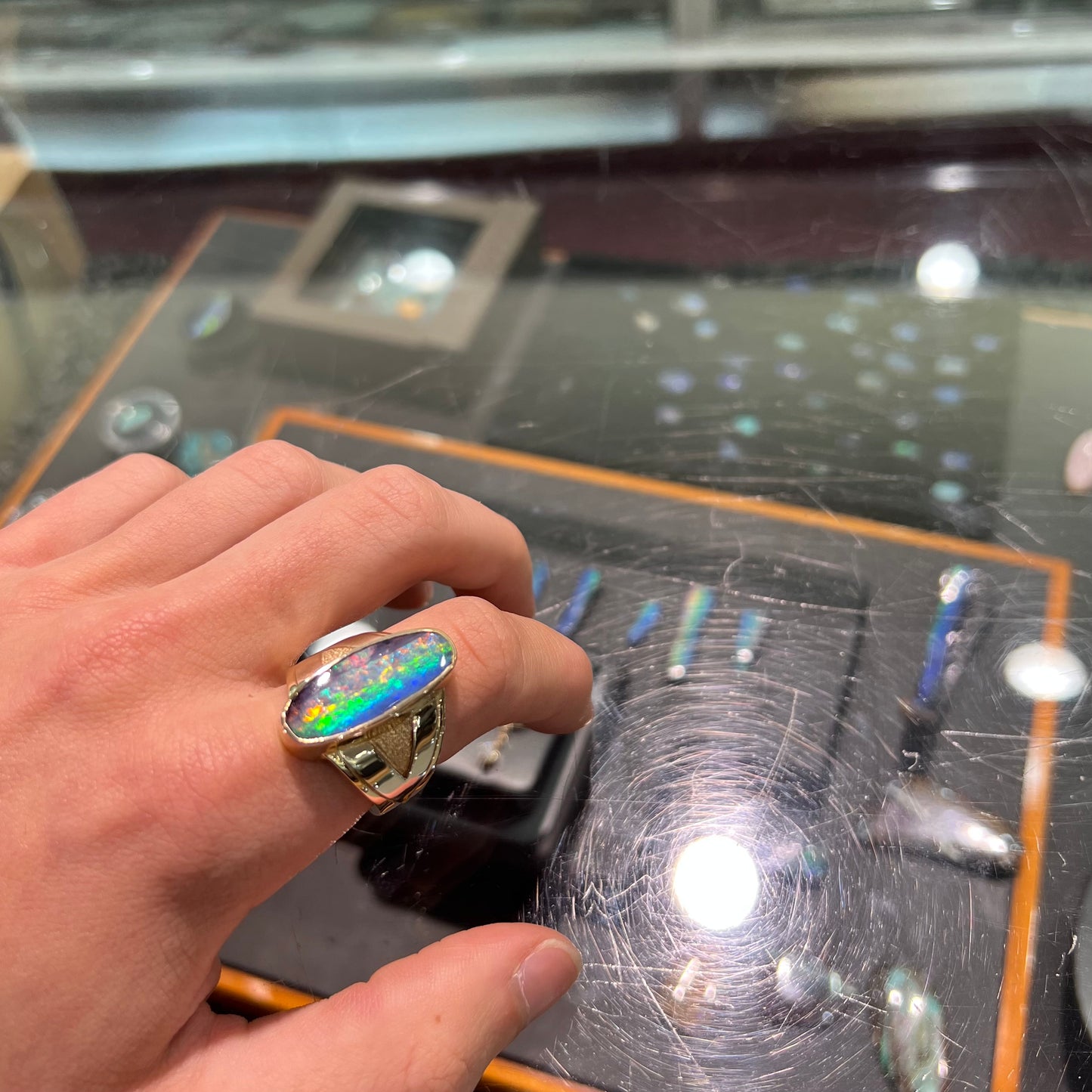 A men's two-tone gold solitaire ring set with a natural boulder opal from Koroit Mining District, Australia.