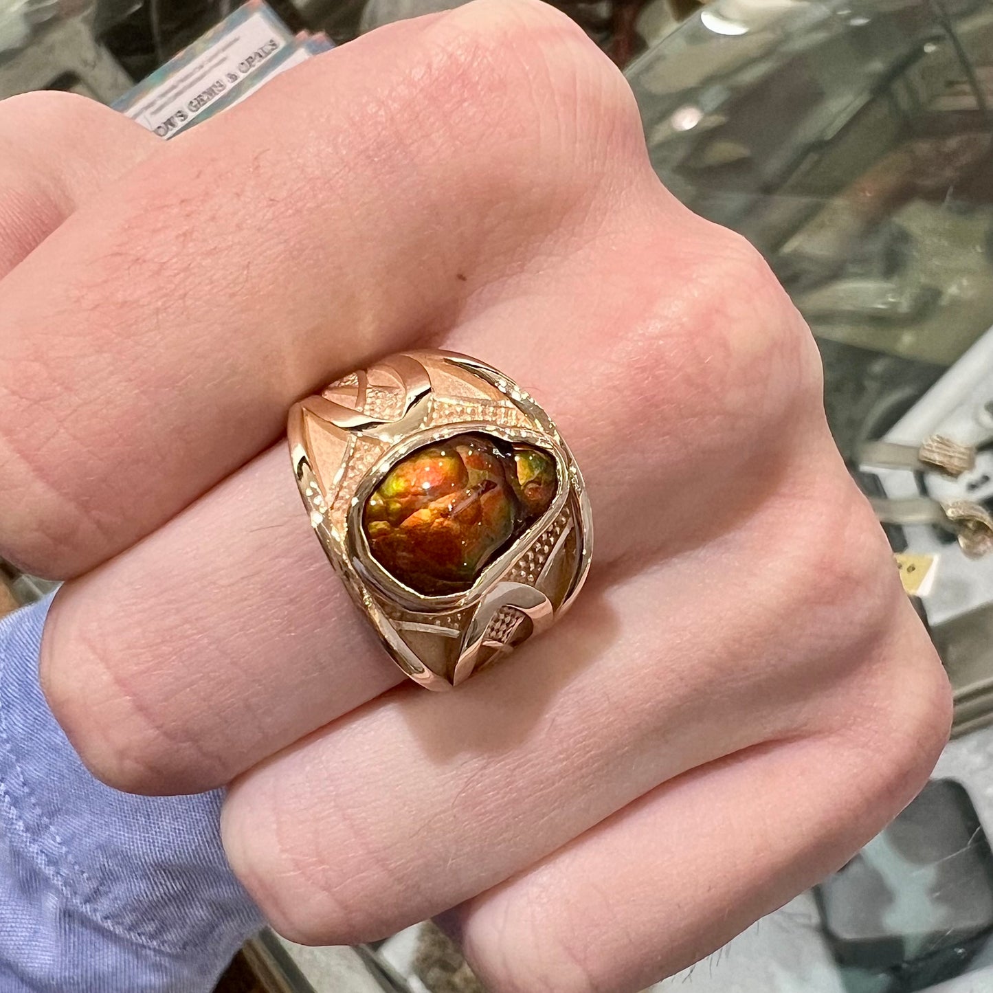 A men's 14kt yellow gold Mexican fire agate ring.