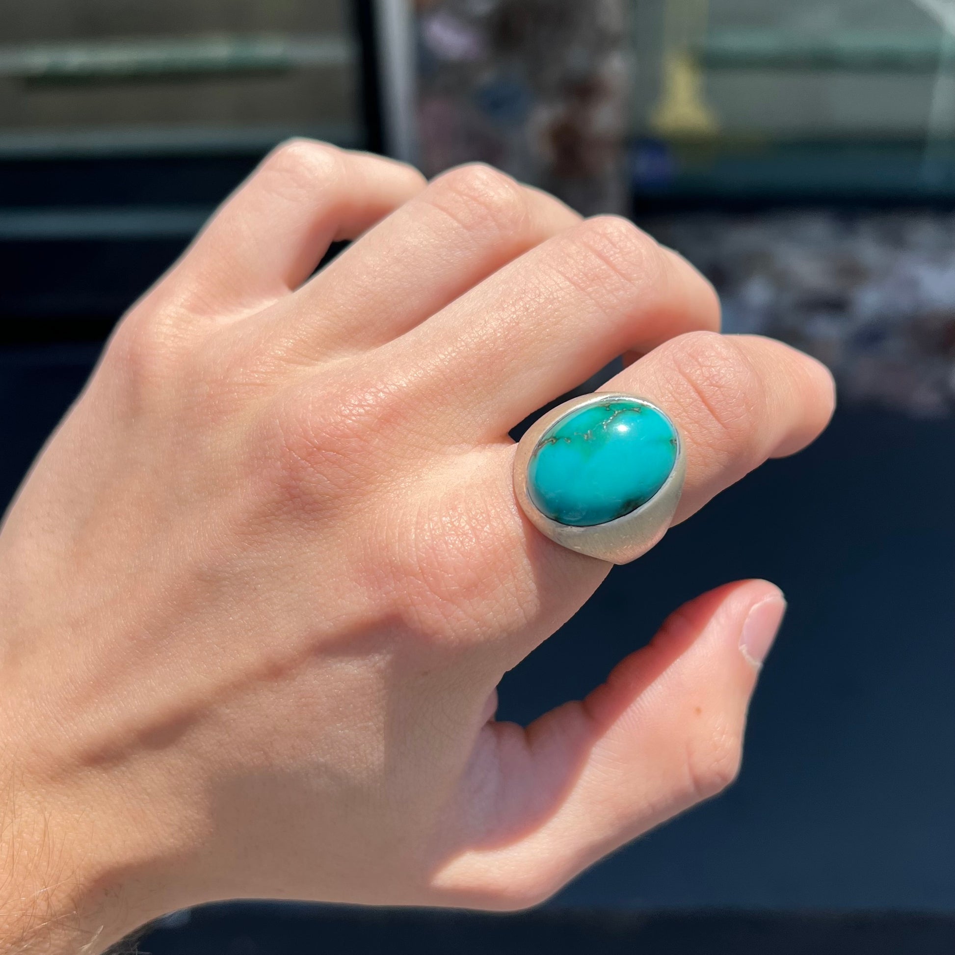 A men's textured silver turquoise solitaire ring.  The turquoise is from Royston Mining District, Nevada.