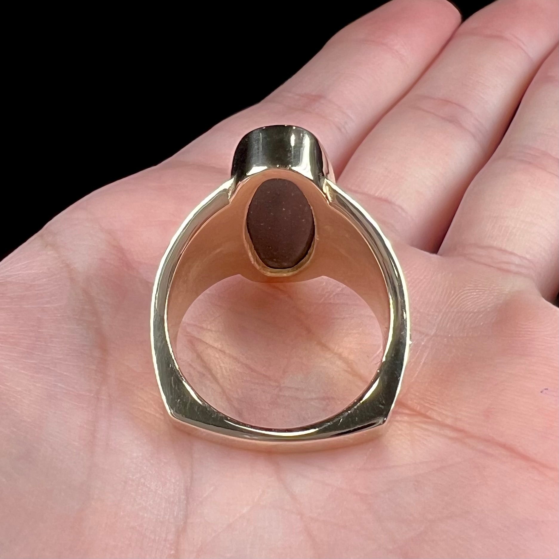 A men's two-tone gold solitaire ring set with a natural boulder opal from Koroit Mining District, Australia.