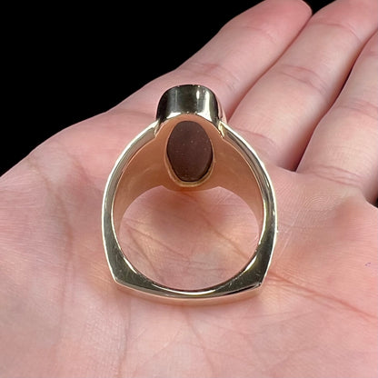 A men's two-tone gold solitaire ring set with a natural boulder opal from Koroit Mining District, Australia.