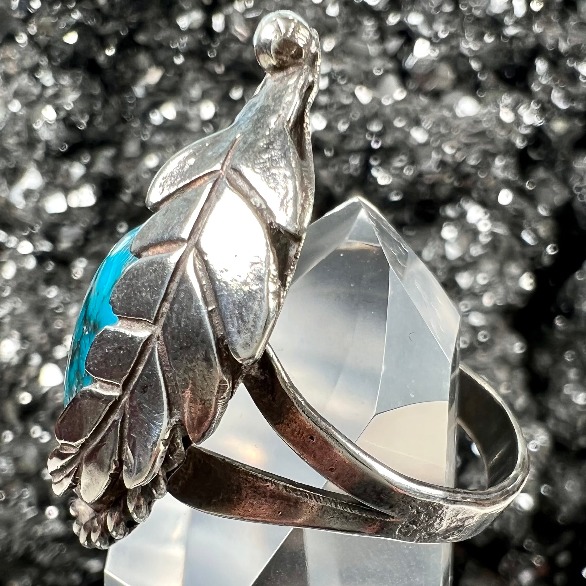 A handmade Navajo men's turquoise ring.  The ring is made with wire and carved silver.