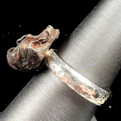 A sterling silver ring set with a Campo del Cielo meteorite.