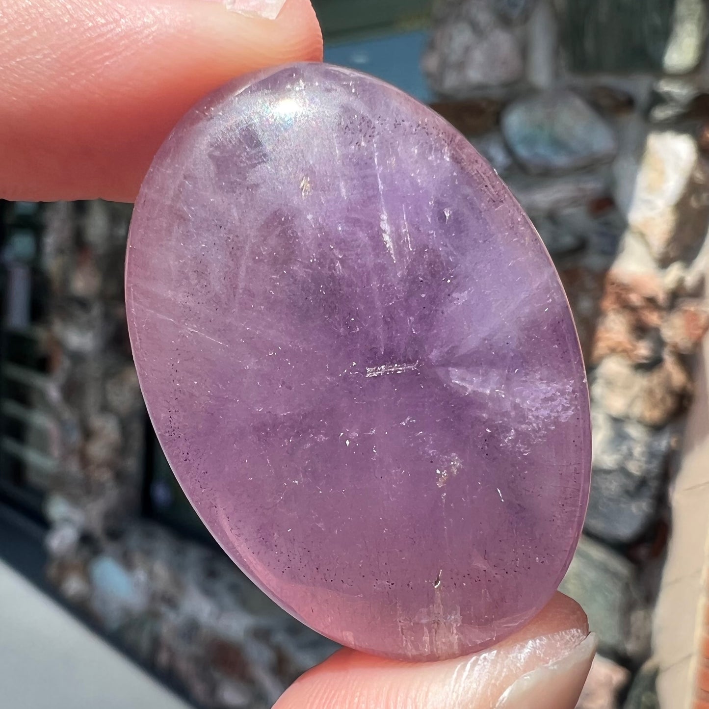 A cabochon cut red amethyst stone from Mexico.  The piece shows a faint star.