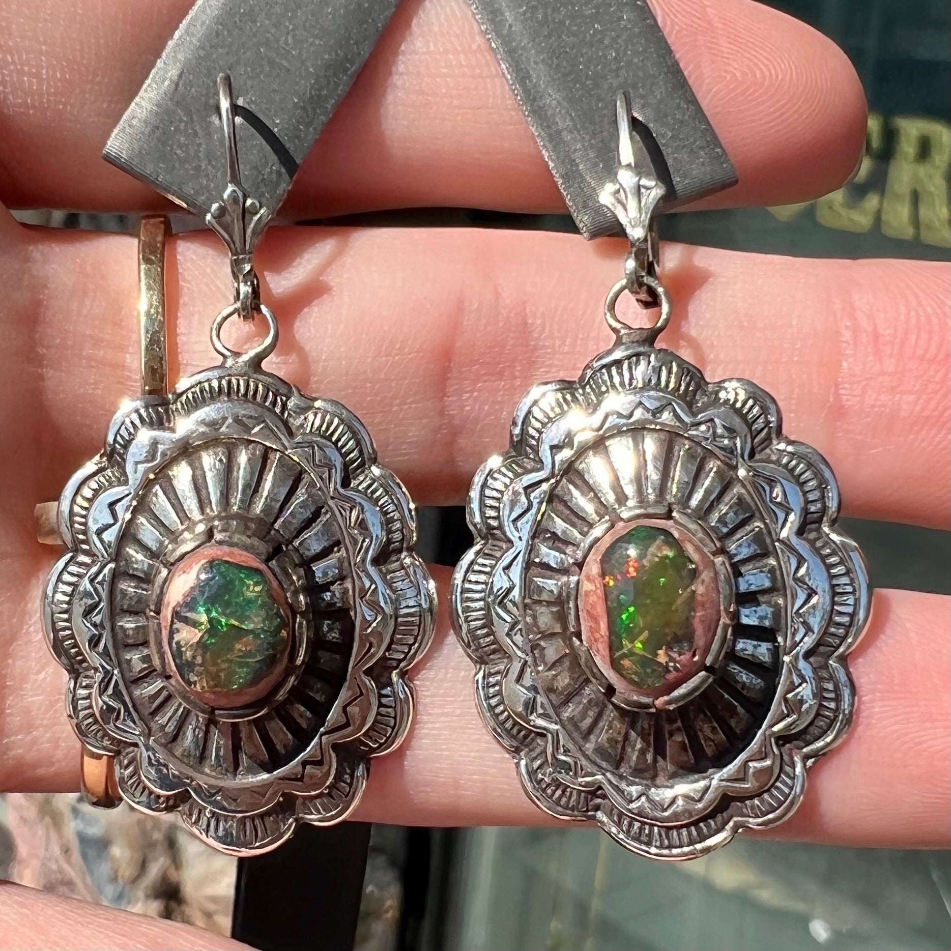 A pair of handmade sterling silver cantera opal earrings.  The earrings are Navajo style by artist Sam Yah.