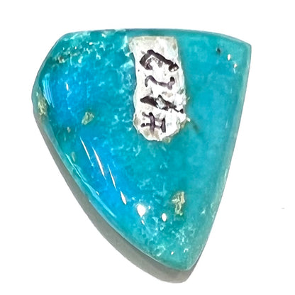 One loose triangular cut cabochon turquoise stone from Sonora, Mexico.