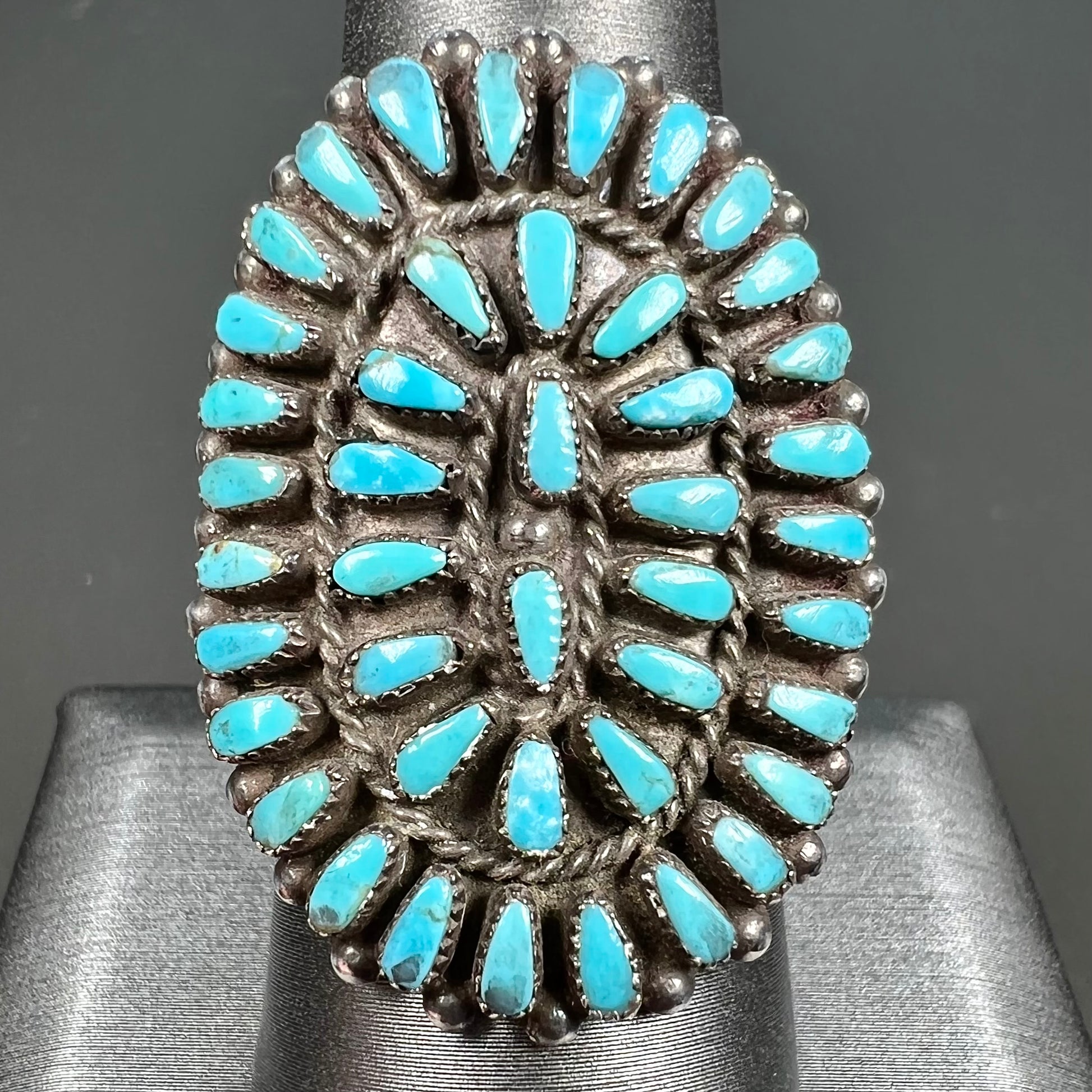 A petit point silver Zuni turquoise ring handmade by New Mexico artist Milburn Dishta.