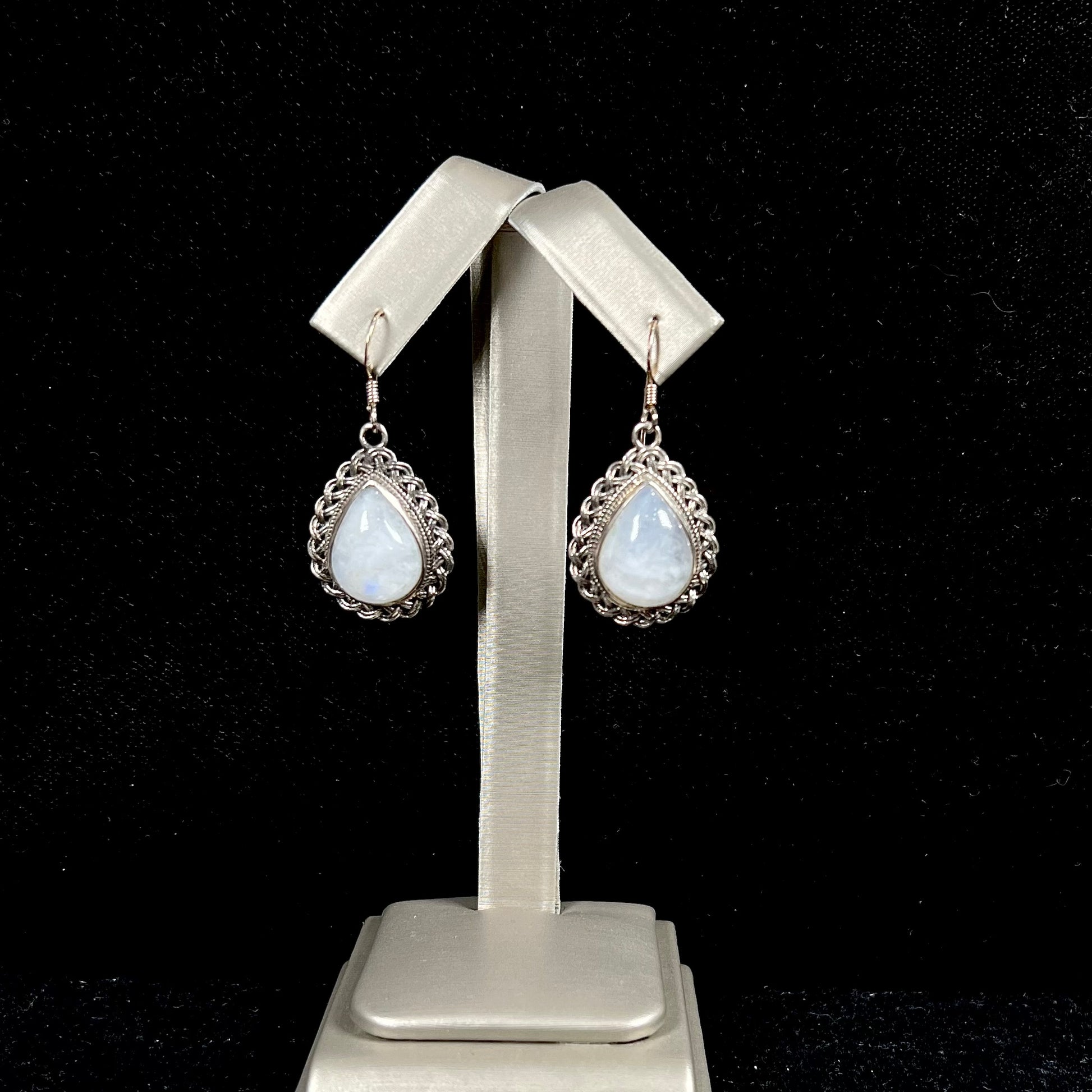 Silver filigree dangle wire earrings set with pear shape moonstones.