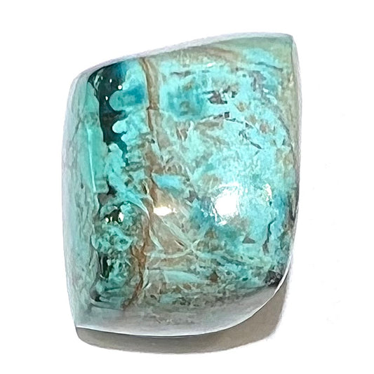 A loose, polished turquoise specimen with azurite inclusions.