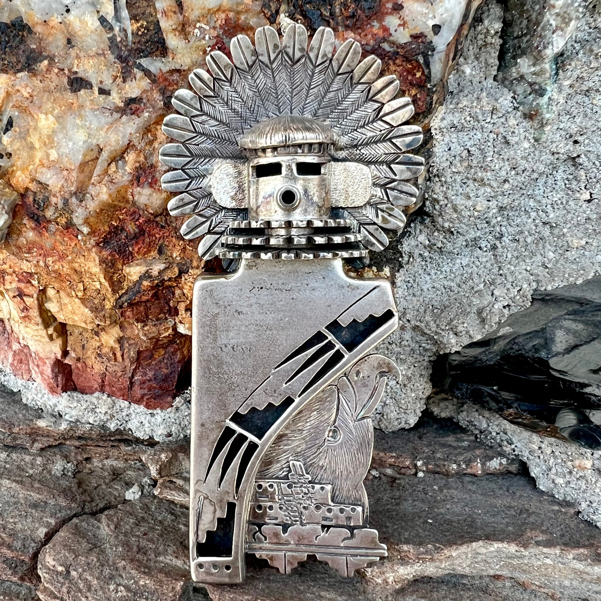 A Morning Singer kachina doll pendant made from sterling silver by Navajo artist Bennie Ration.