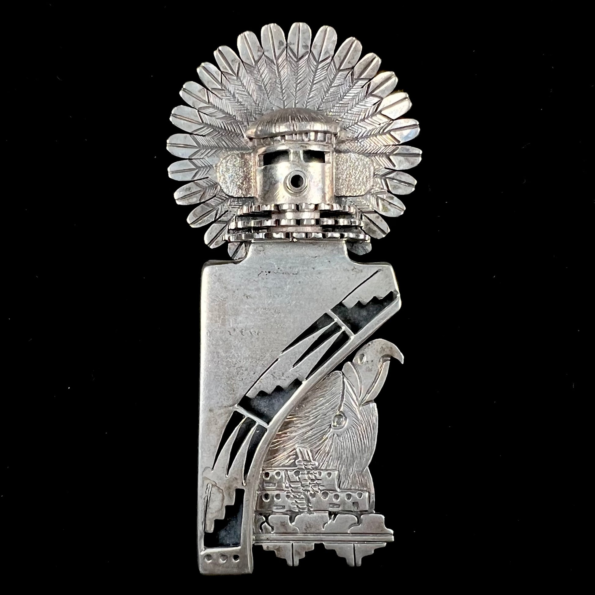 A Morning Singer kachina doll pendant made from sterling silver by Navajo artist Bennie Ration.