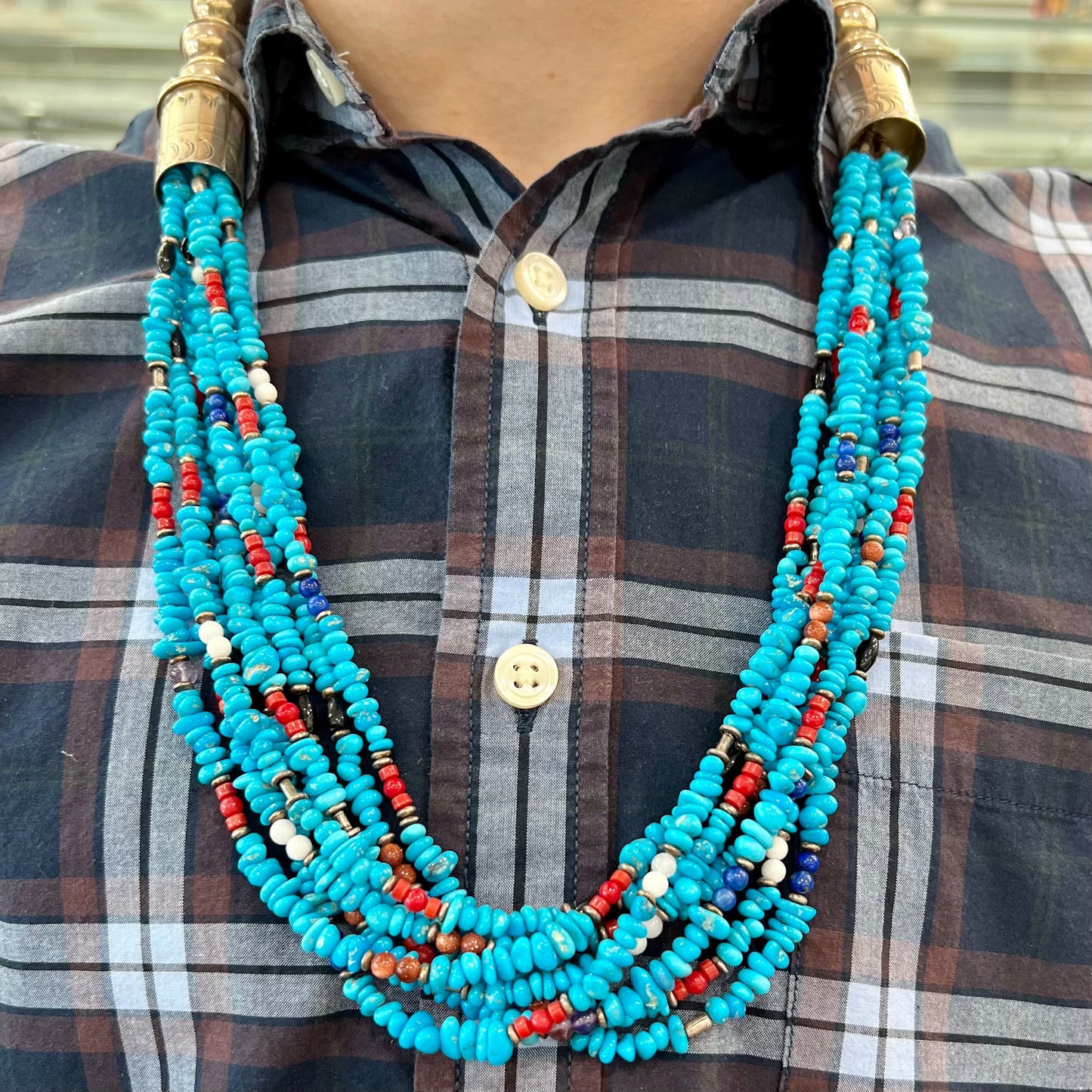 A Navajo Indian-made multistrand Sleeping Beauty turquoise bead necklace with coral, lapis lazuli, goldstone, and onyx accents.