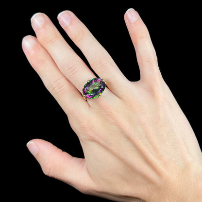 A ladies' large mystic topaz, chrome diopside, and diamond statement ring cast in 14k yellow gold.