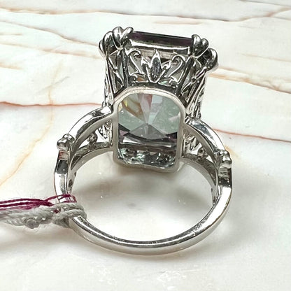 Emerald cut mystic topaz prong set in a decorative sterling silver ring.