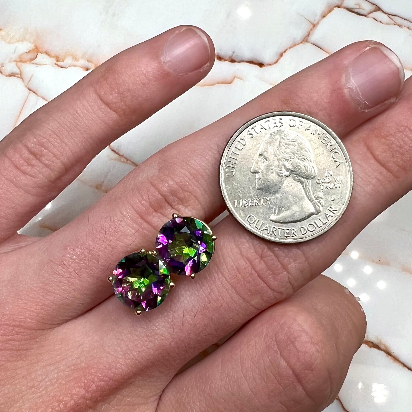 Round cut mystic topaz stones set in yellow gold prong-set push-back earrings.