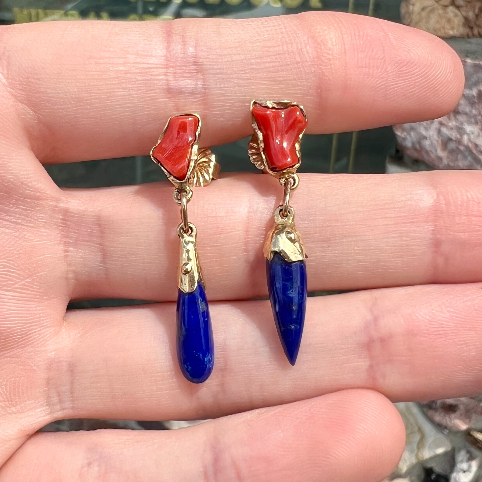 A pair of Navajo-handmade yellow gold dangle earrings set with lapis lazuli and polished coral branches.