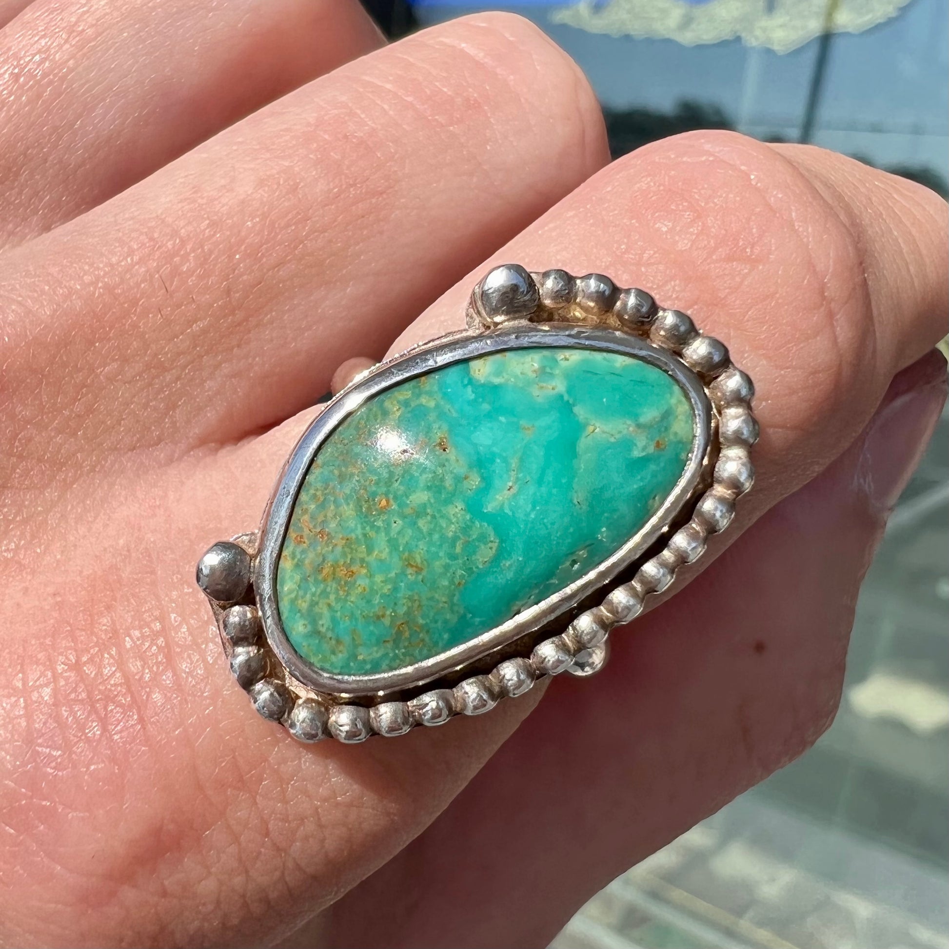 A sterling silver, Native American style green turquoise ring.  The turquoise is from the Royston Mining District.