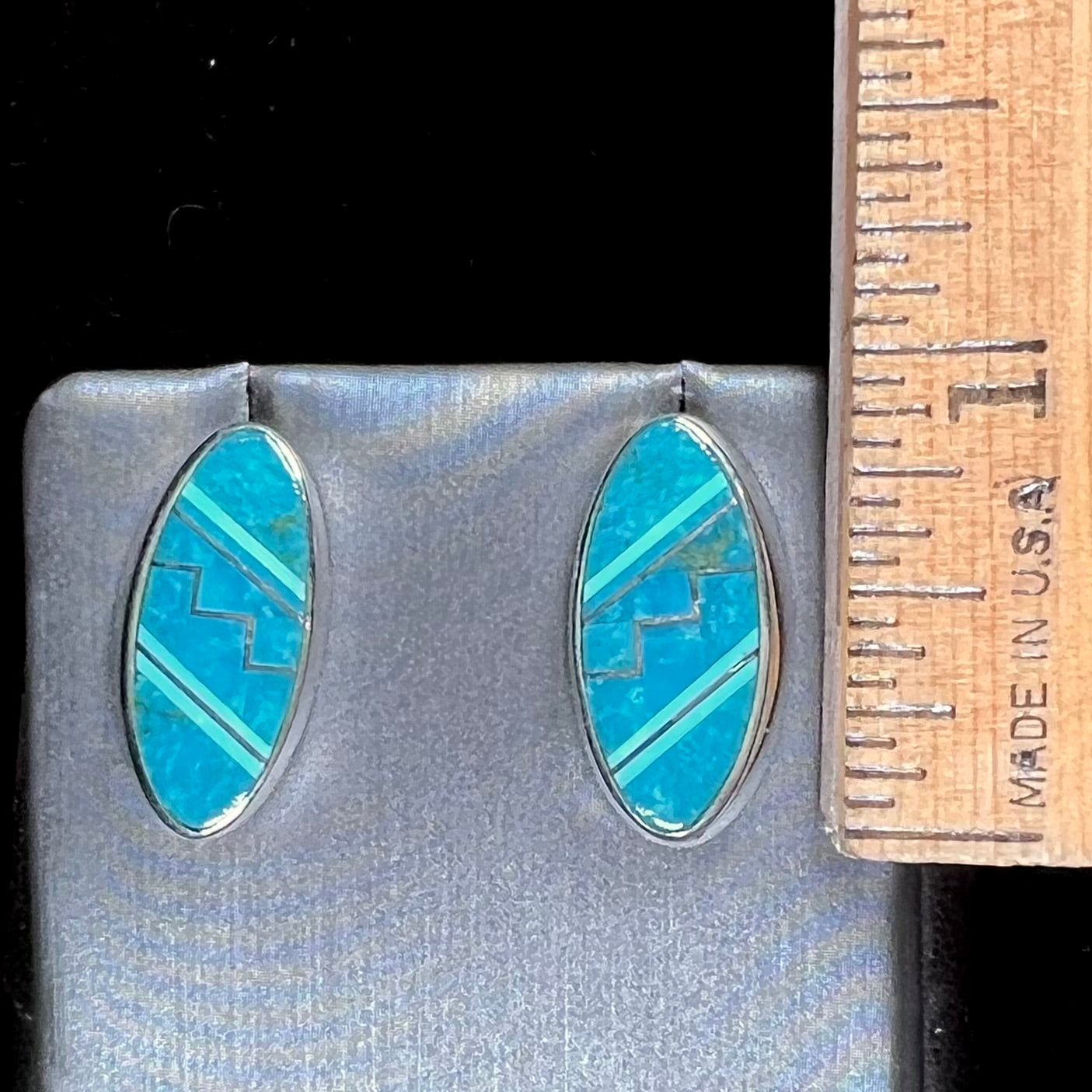 A pair of sterling silver turquoise inlay earrings, handmade by the Zuni artist.