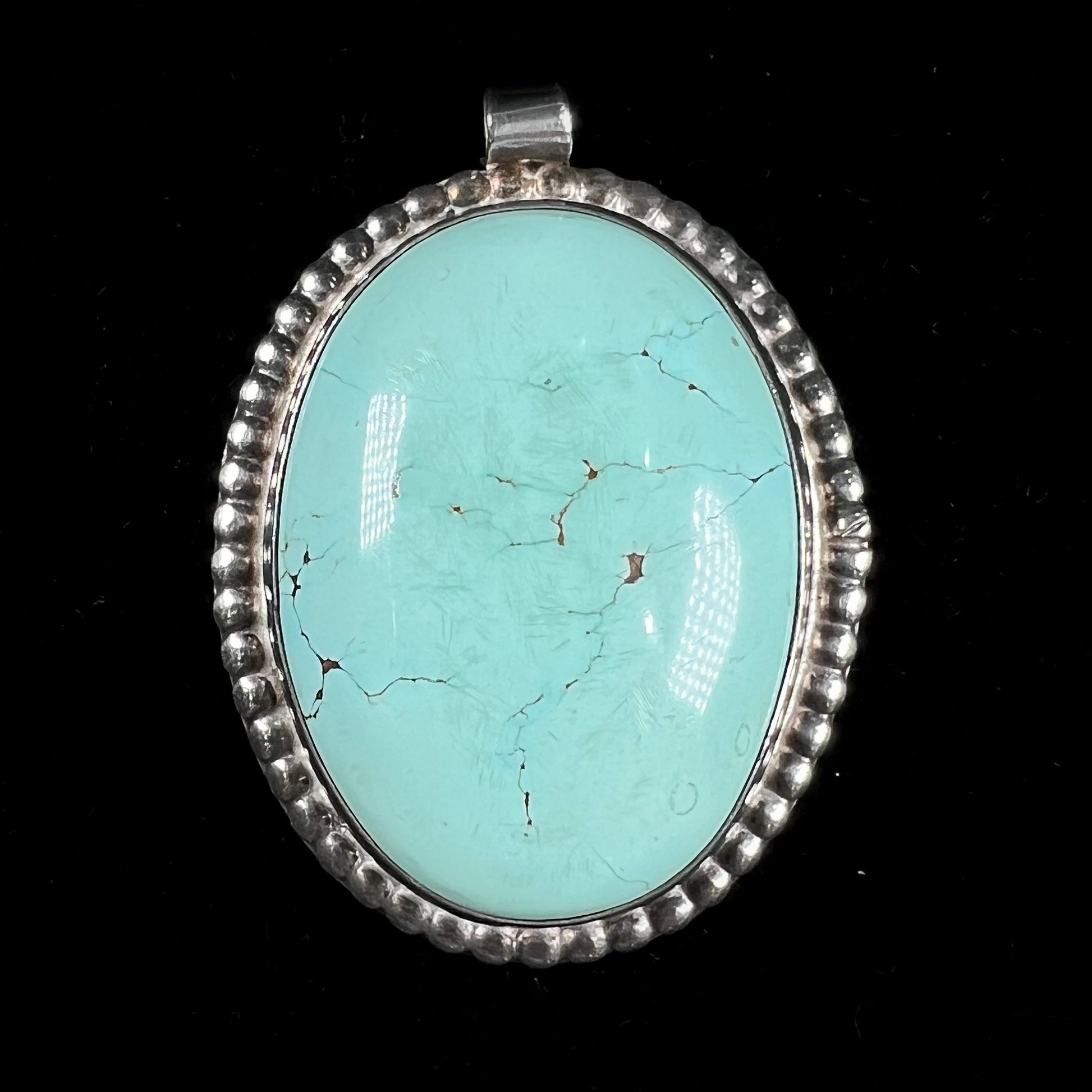A sterling silver Native American pendant set with a piece of blue turquoise from Courtland-Gleeson Mining District, Arizona.