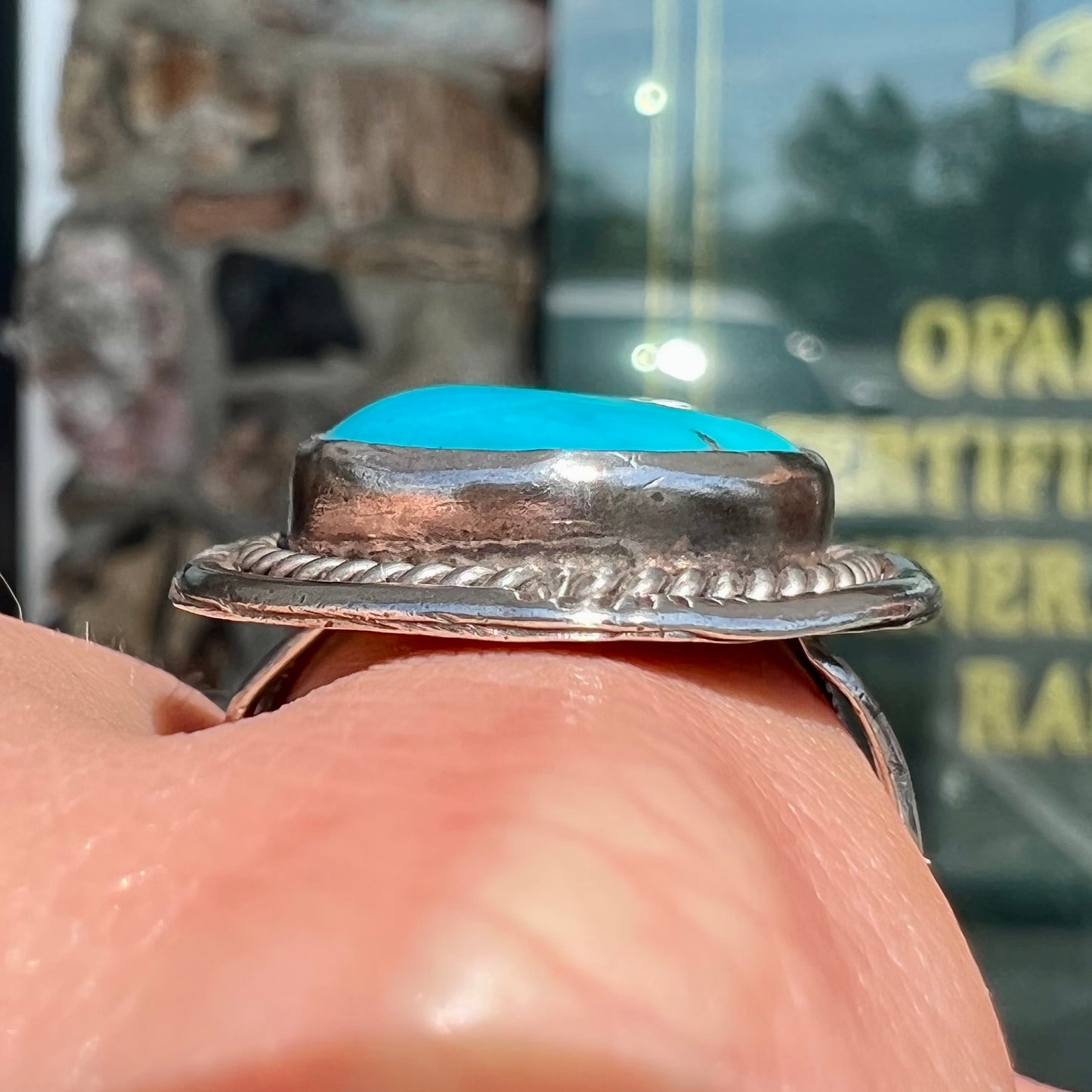 A men's silver, handmade, Navajo turquoise ring.