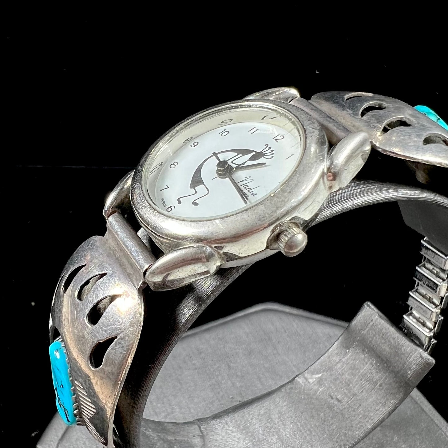 A watch set with two turquoise stones handmade by Navajo artists Arnold and Carleena Goodluck.