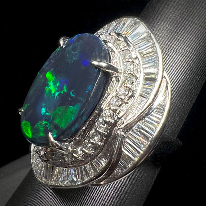 A ladies' platinum diamond halo ring set with a natural black opal stone from Lightning Ridge, Australia.