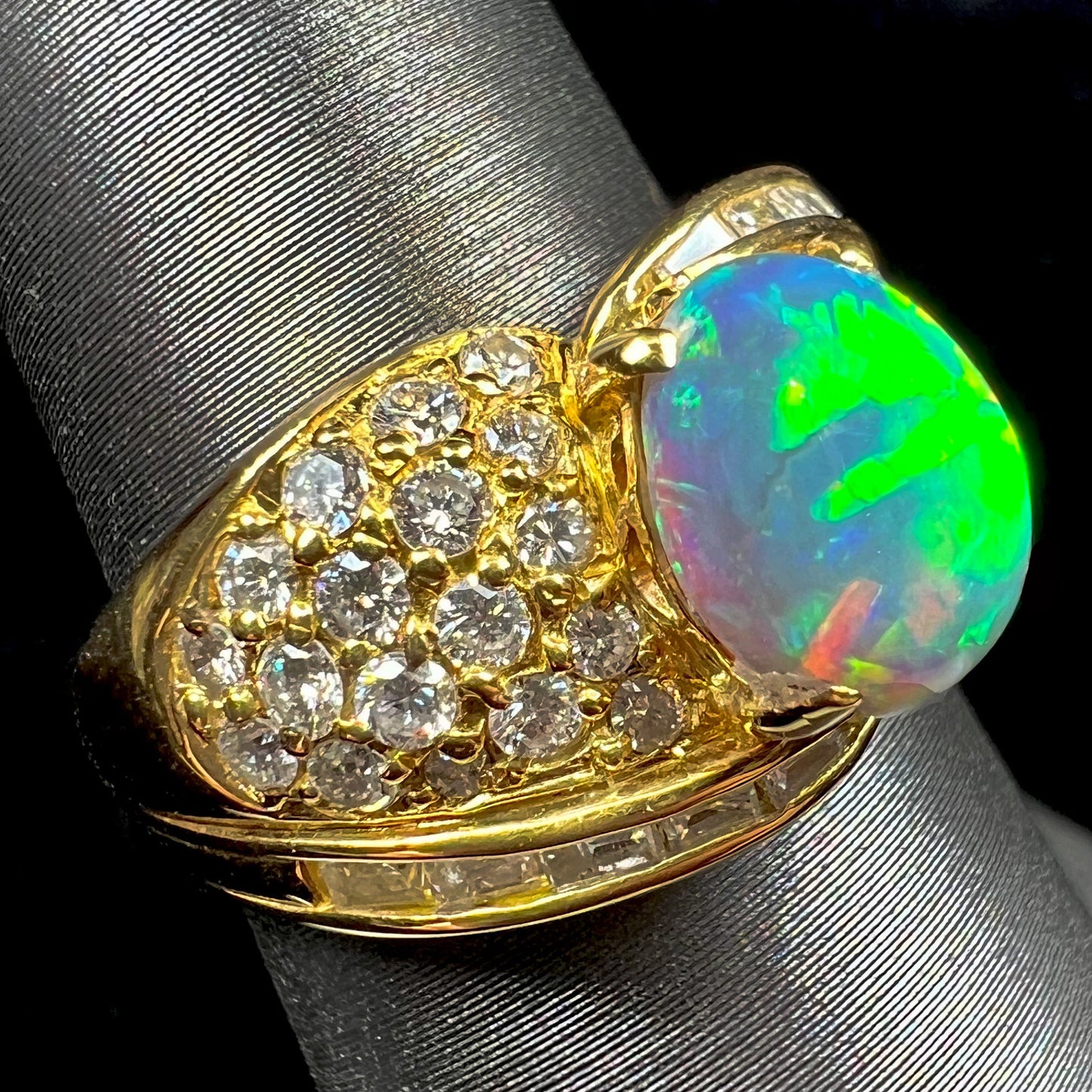 A natural, Australian black opal and diamond ring cast in 18 karat yellow gold..