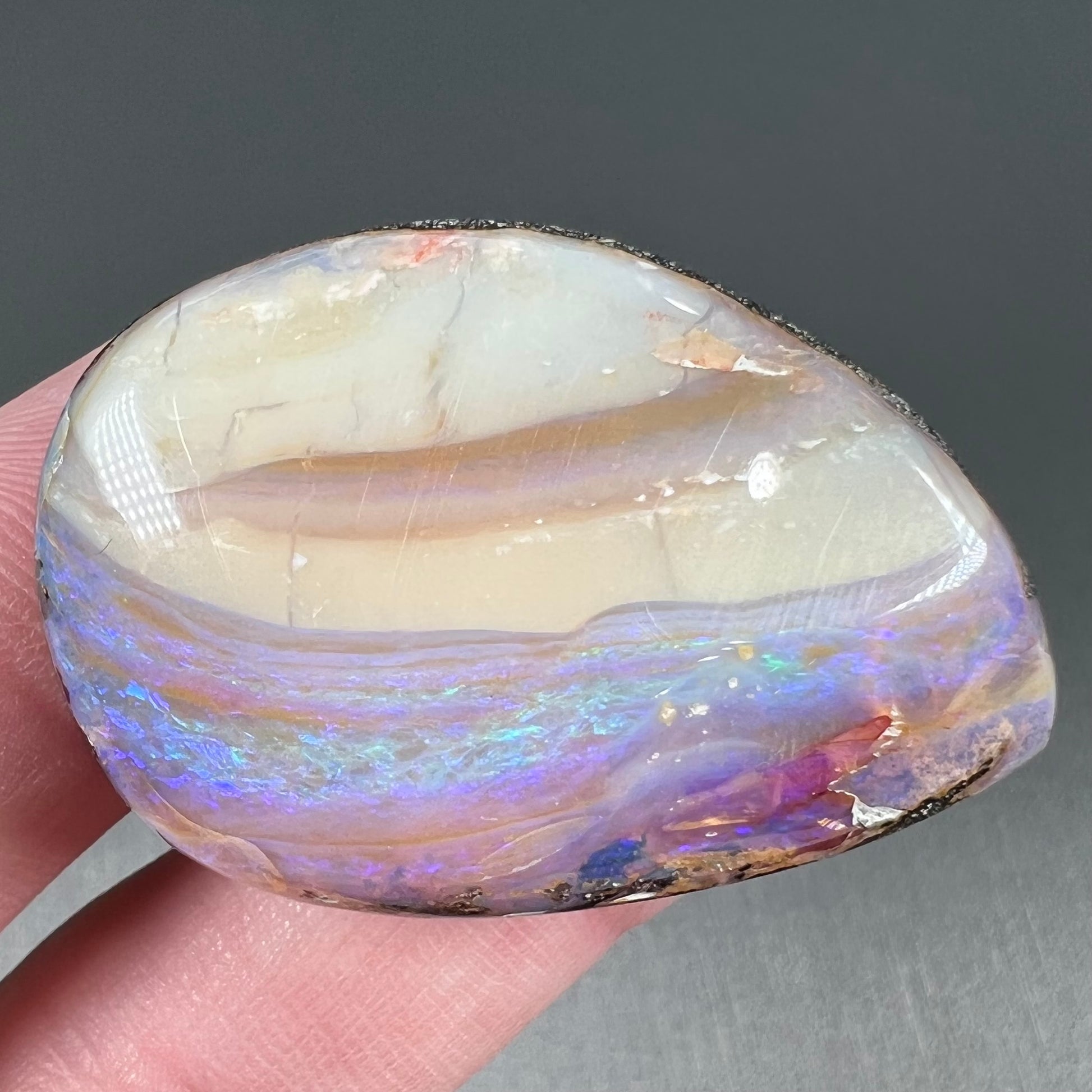 A loose, drop shaped Australian boulder opal from Quilpie Mining District.