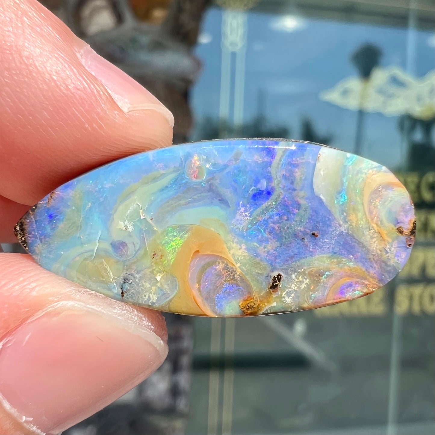 A loose, natural, pear shaped boulder opal stone from Quilpie, Australia.