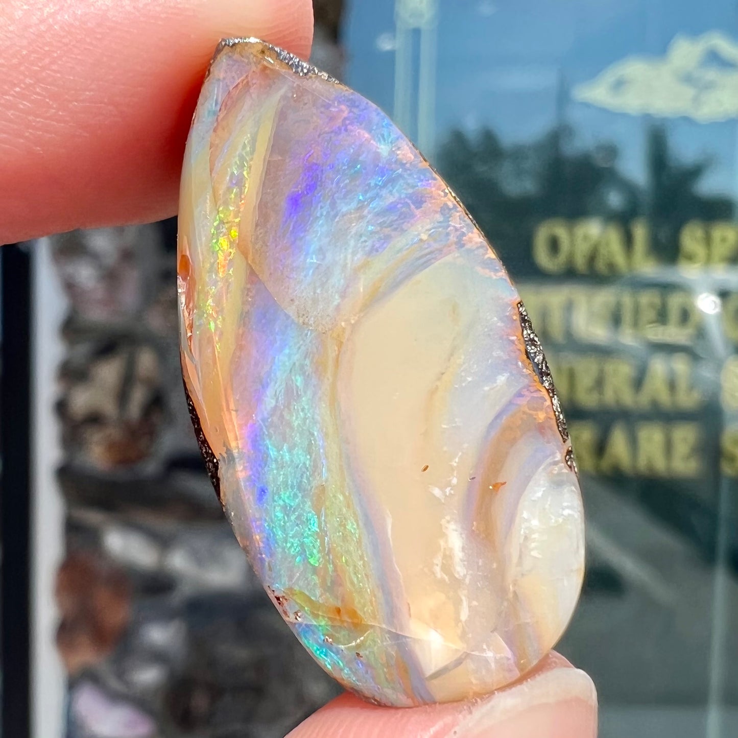 A loose, pear shaped cabochon cut boulder opal stone from Quilpie, Australia.