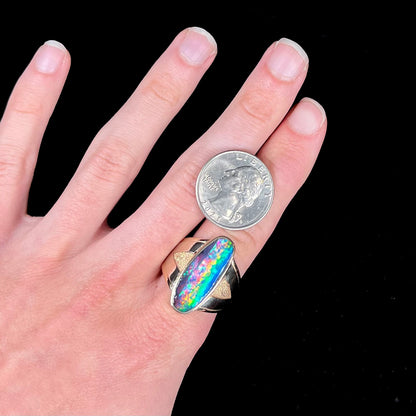 A men's two-tone gold solitaire ring set with a natural boulder opal from Koroit Mining District, Australia.