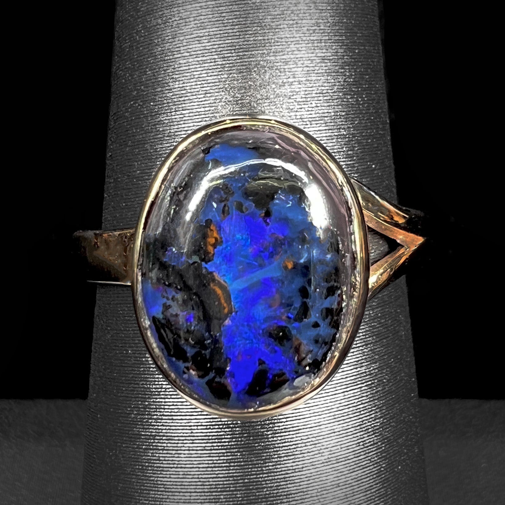 A handmade ladies' yellow gold boulder opal ring.  The opal is a natural purple Yowah nut boulder opal.