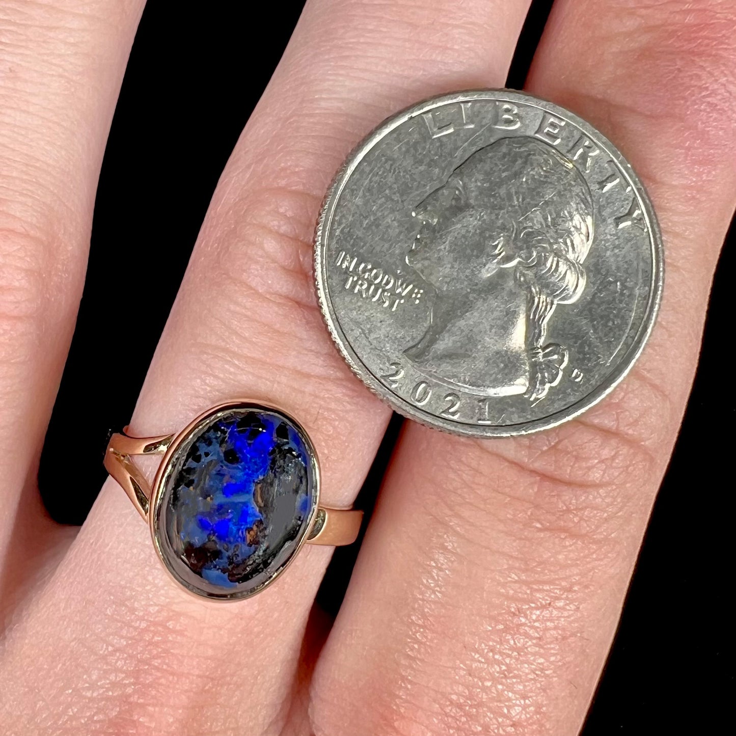 A handmade ladies' yellow gold boulder opal ring.  The opal is a natural purple Yowah nut boulder opal.