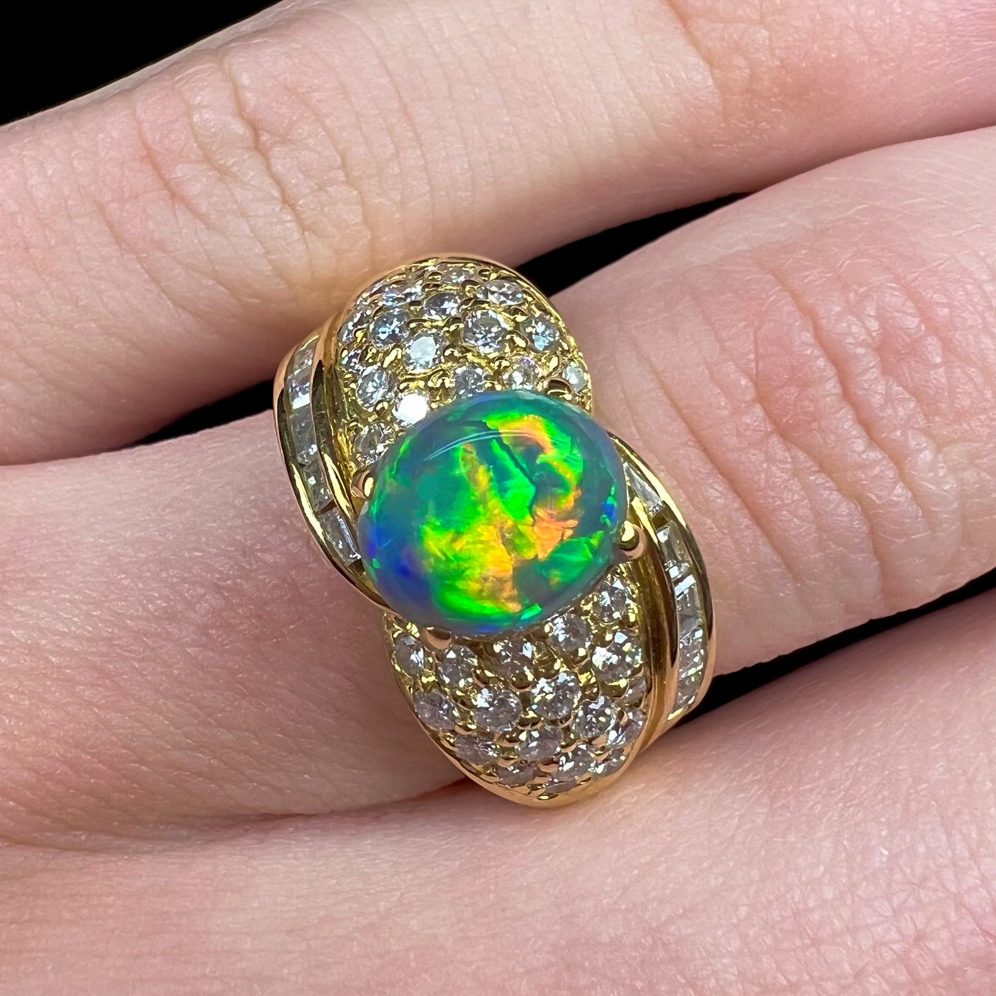 A natural, Australian black opal and diamond ring cast in 18 karat yellow gold..