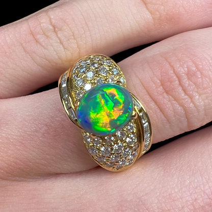 A natural, Australian black opal and diamond ring cast in 18 karat yellow gold..