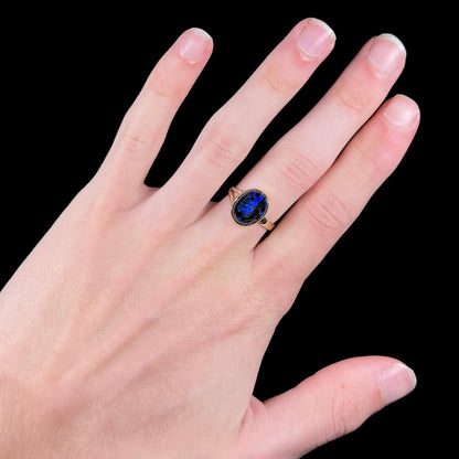 A handmade ladies' yellow gold boulder opal ring.  The opal is a natural purple Yowah nut boulder opal.