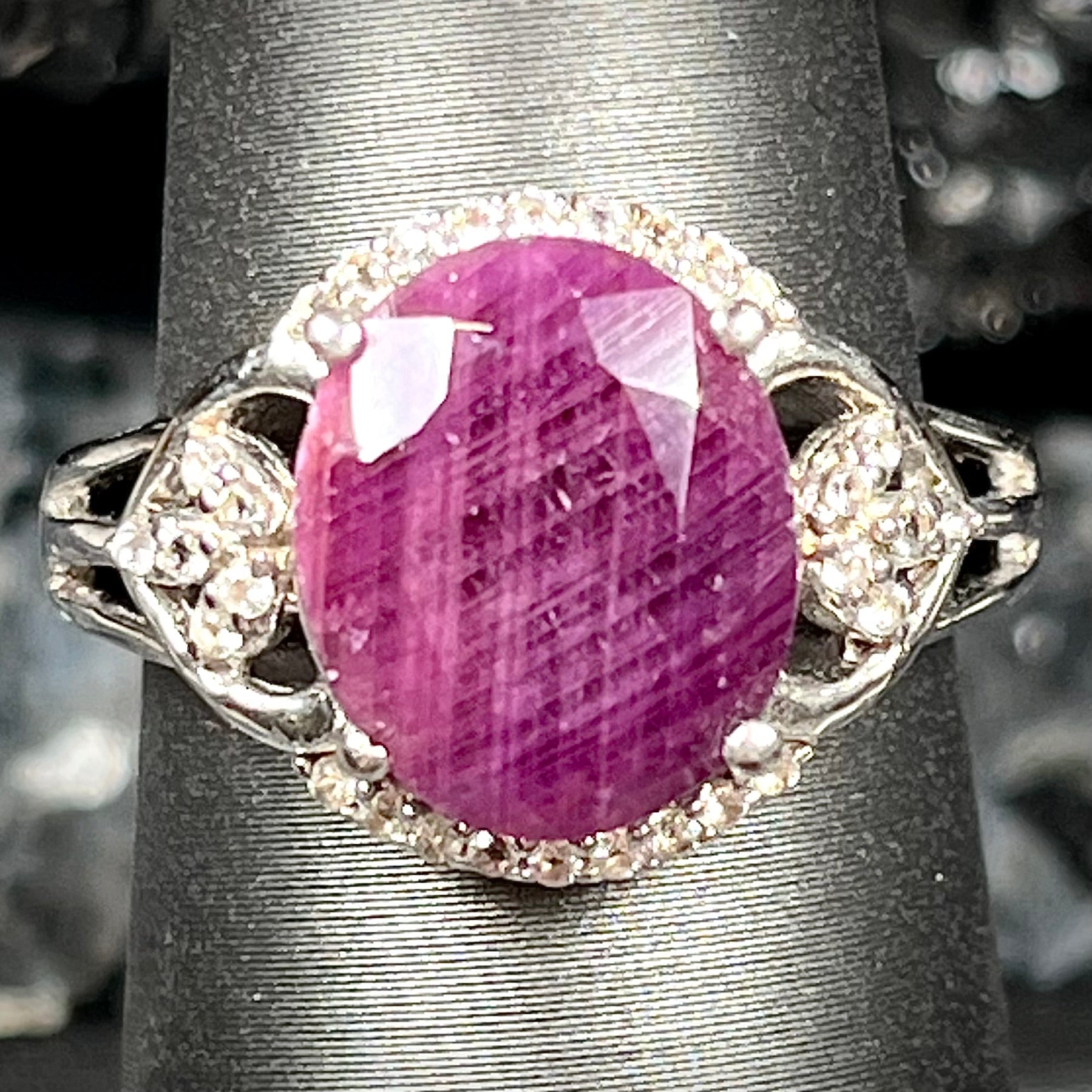 An oval cut natural ruby set in a sterling silver ring.