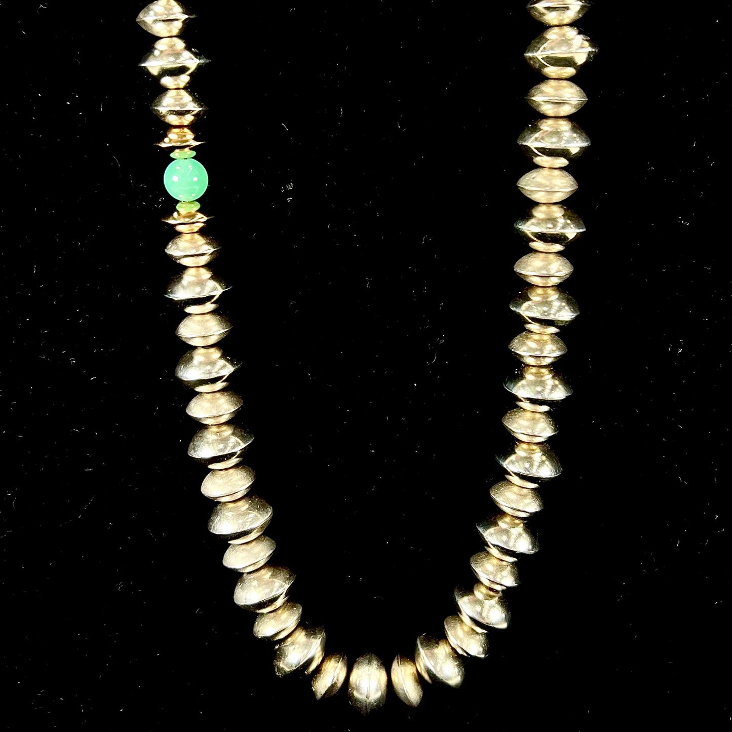 A silver, gold, and chrysoprase bead necklace handmade by Navajo artist, Alfred Joe.
