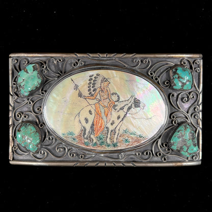 A men's Navajo-made white brass belt buckle set with turquoise nuggets and a mother of pearl stone etched with a Native American riding a horse.