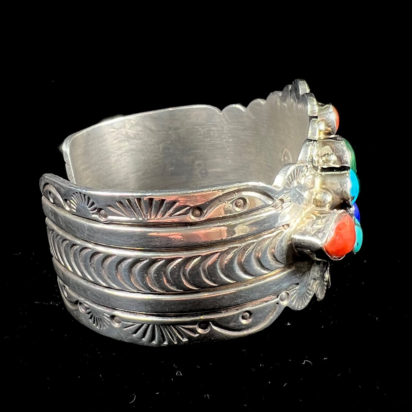 A sterling silver ladies' Navajo cuff bracelet set with turquoise, malachite, lapis lazuli, and coral stones.