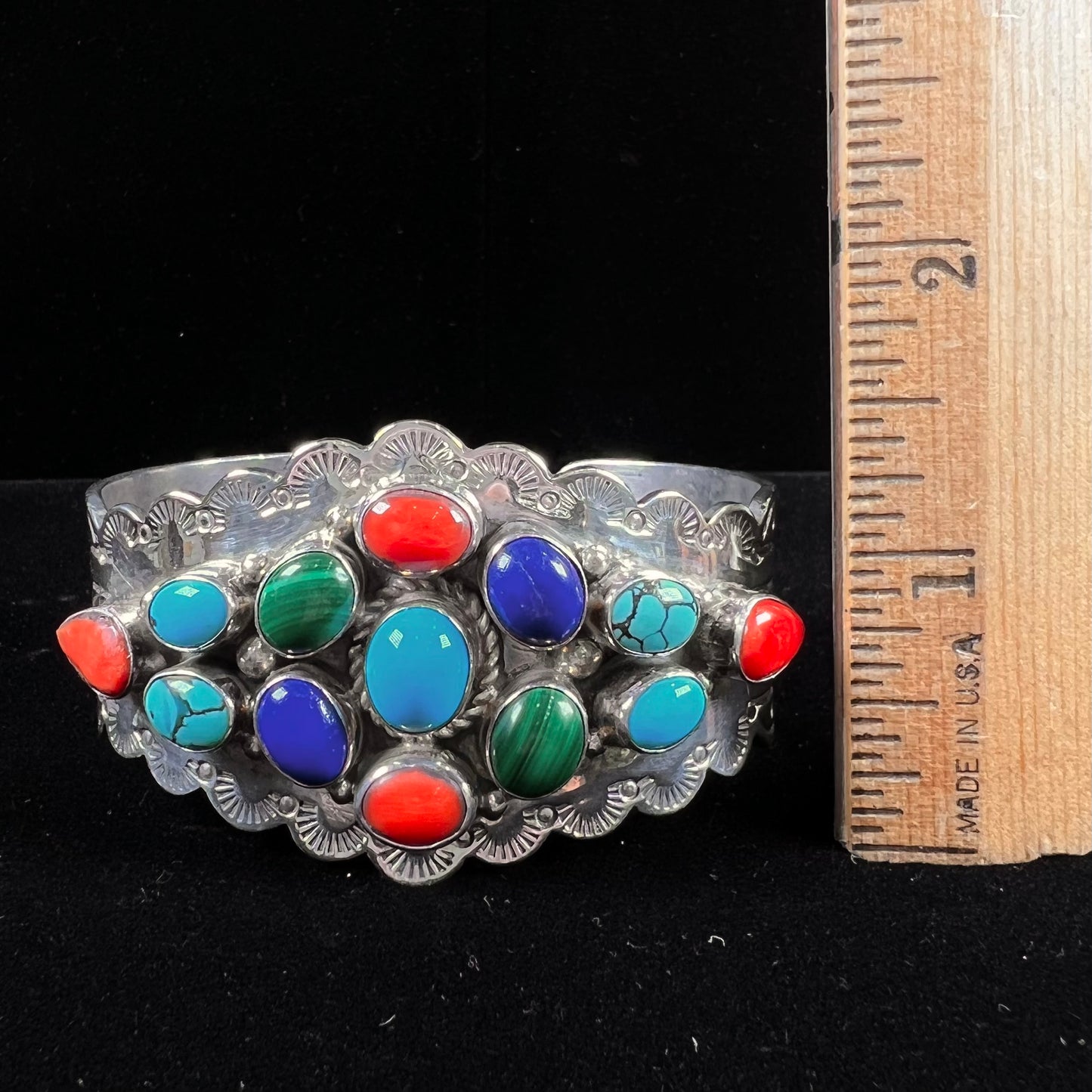 A sterling silver ladies' Navajo cuff bracelet set with turquoise, malachite, lapis lazuli, and coral stones.