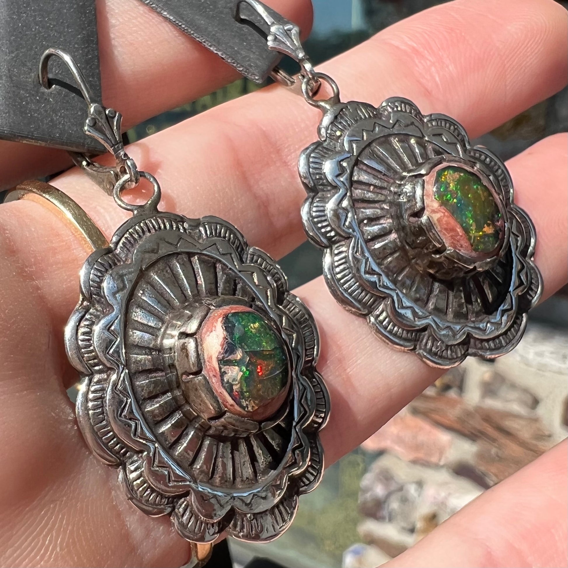 A pair of handmade sterling silver cantera opal earrings.  The earrings are Navajo style by artist Sam Yah.