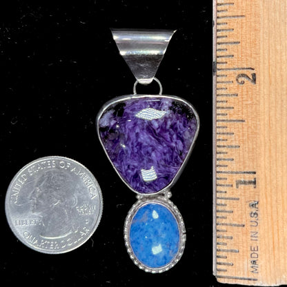 A sterling silver pendant set with polished charoite and lapis lazuli stones, hand signed "KK" by the artist.